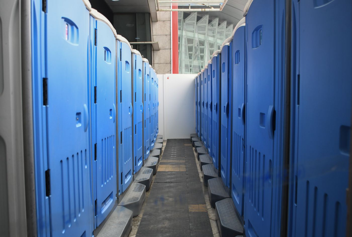 Blue portable restrooms in an outdoor work setting